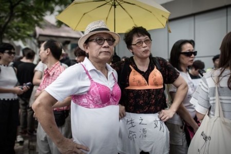 Bra-wearing activists march Hong Kong protest